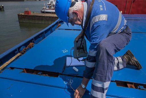 worker using torch cutter to cut through metal